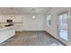 Kitchen with stainless appliances, modern white cabinets and a bright breakfast area with lots of natural light at 4118 Haleston Rd, Duluth, GA 30097