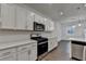 Well-equipped kitchen featuring stainless steel appliances, including a gas range and microwave at 4118 Haleston Rd, Duluth, GA 30097