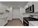 Beautiful kitchen with stainless steel appliances, granite countertops, and modern white cabinets, bright with recessed lighting at 4118 Haleston Rd, Duluth, GA 30097