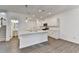 Bright kitchen with stainless appliances, large island, hardwood floors, and a staircase to the second floor at 4118 Haleston Rd, Duluth, GA 30097