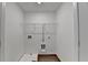 Laundry room with washer hookups, wood-look floors, and wire shelving at 4118 Haleston Rd, Duluth, GA 30097