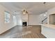 Open living room with a cozy fireplace, recessed lights, and hardwood floors at 4118 Haleston Rd, Duluth, GA 30097