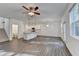 Open concept living area with ceiling fan, modern kitchen with stainless appliances, lots of natural light from windows at 4118 Haleston Rd, Duluth, GA 30097