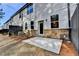 Private patio area with stone accents and a black fence at 4118 Haleston Rd, Duluth, GA 30097