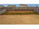 Expansive, fenced backyard featuring a mix of grass, mulch and green groundcover, ideal for outdoor activities and entertaining at 4480 Sunflower Cir, Cumming, GA 30040