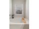 Relaxing tub with faucet, window and wooden bath caddy at 4480 Sunflower Cir, Cumming, GA 30040