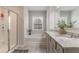 Bright bathroom featuring a double vanity, granite countertops, large mirror, and a tub with shower at 4480 Sunflower Cir, Cumming, GA 30040