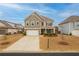 Charming two-story home with stone accents, landscaped front yard, and attached two-car garage at 4480 Sunflower Cir, Cumming, GA 30040