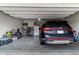 Spacious garage with a black SUV and plenty of storage space at 4480 Sunflower Cir, Cumming, GA 30040