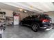 Clean garage with SUV, shelving, and overhead lighting at 4480 Sunflower Cir, Cumming, GA 30040