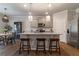 Open-concept kitchen with granite countertops, stainless steel appliances, and seating at the island at 4480 Sunflower Cir, Cumming, GA 30040