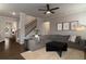 Bright living room with stairs, gray sofa, fireplace, and stylish decor at 4480 Sunflower Cir, Cumming, GA 30040