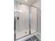 Modern shower with sliding glass doors, a built-in bench, and shelving for a clean and organized space at 4480 Sunflower Cir, Cumming, GA 30040