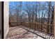 Spacious wooden back deck with wooden railing, and a beautiful view of the woods at 7290 Weber St, Atlanta, GA 30349