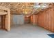 Unfinished basement with insulation, exposed ceiling, and cement wall at 7290 Weber St, Atlanta, GA 30349