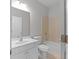 Bathroom features a shower over tub combo, white vanity and neutral tile at 7290 Weber St, Atlanta, GA 30349