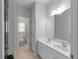 Bright bathroom featuring double sinks, white vanity and tile floors at 7290 Weber St, Atlanta, GA 30349