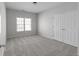 Bedroom featuring neutral paint, plush carpeting, a window and closet at 7290 Weber St, Atlanta, GA 30349
