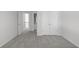 Bedroom featuring grey carpet and white trim with closet and bath access at 7290 Weber St, Atlanta, GA 30349