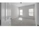 Neutral bedroom featuring plush carpeting, two windows and freshly painted walls at 7290 Weber St, Atlanta, GA 30349
