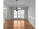 Light-filled dining room with large window, chandelier, and decorative trim, providing a perfect setting for meals at 7290 Weber St, Atlanta, GA 30349