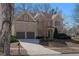 Charming two-story brick home featuring a two-car garage and manicured landscaping at 7290 Weber St, Atlanta, GA 30349