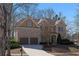 Charming two-story brick home featuring a two-car garage and manicured landscaping at 7290 Weber St, Atlanta, GA 30349