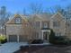 Charming two-story brick home featuring a two-car garage and manicured landscaping at 7290 Weber St, Atlanta, GA 30349