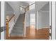 Open foyer with hardwood floors, staircase, and views into other rooms at 7290 Weber St, Atlanta, GA 30349