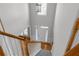 View from stairs overlooking the foyer with soaring ceilings, hardwood floors and a bright front door at 7290 Weber St, Atlanta, GA 30349
