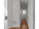 Hallway with hardwood floors leading to a half bath, showcasing convenient access and neutral tones at 7290 Weber St, Atlanta, GA 30349