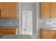 Kitchen view showcasing granite countertops and tiled backsplash, connecting to the laundry room at 7290 Weber St, Atlanta, GA 30349