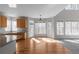 Bright kitchen area featuring an island, wooden cabinets, hardwood floors, and many windows at 7290 Weber St, Atlanta, GA 30349