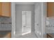 View from the kitchen showing the laundry room, with white marble-patterned floors at 7290 Weber St, Atlanta, GA 30349