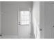 Laundry room with white marble patterned floors and a bright white door to the backyard at 7290 Weber St, Atlanta, GA 30349