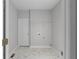 Bright laundry room with marble-patterned floors and a wire shelf for storage at 7290 Weber St, Atlanta, GA 30349