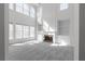 Grand living room with fireplace, built-ins, and expansive windows, providing a bright and inviting atmosphere at 7290 Weber St, Atlanta, GA 30349