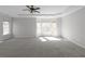 Large primary bedroom boasts a trey ceiling, fan and lots of sunlight at 7290 Weber St, Atlanta, GA 30349