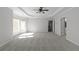 Primary bedroom with a trey ceiling, fan, carpeted floors and a view into bathroom at 7290 Weber St, Atlanta, GA 30349