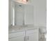 Bright bathroom with a large mirror above a white vanity, offering a clean and contemporary design at 1115 Larkin Dr, Buford, GA 30518