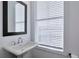 Bathroom features white sink with mirror, and large window for natural light at 1115 Larkin Dr, Buford, GA 30518