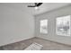Bedroom with carpet, ceiling fan, and two windows overlooking neighborhood at 1115 Larkin Dr, Buford, GA 30518