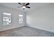 Bedroom with carpet, ceiling fan, and two windows at 1115 Larkin Dr, Buford, GA 30518