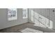 Sunlit bedroom with neutral carpet, closet and double windows at 1115 Larkin Dr, Buford, GA 30518