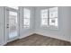 Bright room features hardwood floors, a glass paneled door, and large windows at 1115 Larkin Dr, Buford, GA 30518