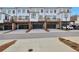 Back exterior of townhomes with garages, balconies, and parking. An ideal blend of privacy and community at 1115 Larkin Dr, Buford, GA 30518