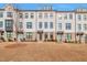 Modern townhome featuring painted brick, black-framed windows and inviting entryway at 1115 Larkin Dr, Buford, GA 30518