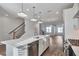 Open kitchen with stainless appliances, quartz counters and view into the living room at 1115 Larkin Dr, Buford, GA 30518