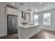 Bright kitchen featuring stainless steel appliances, island and pendant lighting at 1115 Larkin Dr, Buford, GA 30518