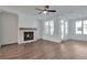 Bright living room with fireplace, ceiling fan and wood floors at 1115 Larkin Dr, Buford, GA 30518